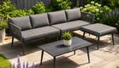 The five-seater garden furniture set includes a sofa, padded cushions, matching stool and wood-look table