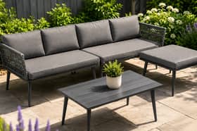 The five-seater garden furniture set includes a sofa, padded cushions, matching stool and wood-look table