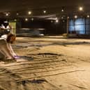 Senior conservator Diana McCormack making final checks on the Trafalgar Sail before its limited display at Portsmouth Historic Dockyard