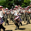 Beating Retreat rehearsals at HMS Excellent on Whale Island, with Royal Marines Band Service musicians parading through the grounds amid the hot temperatures.