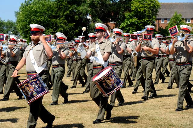 Beating Retreat rehearsals at HMS Excellent on Whale Island, with Royal Marines Band Service musicians parading through the grounds amid the hot temperatures.