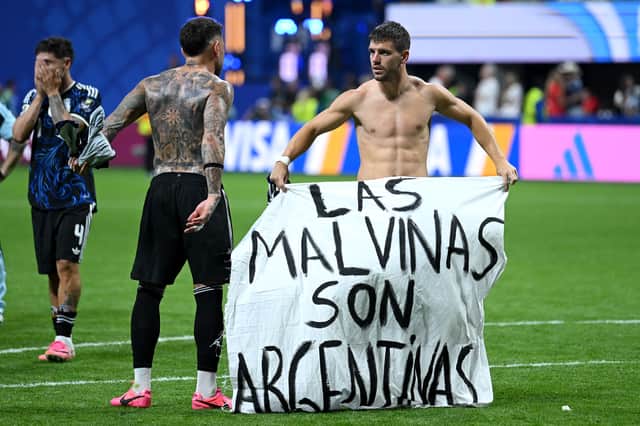 Giovani Lo Celso of Argentina holds a banner after the 2-1 win during the FIFA World Cup 2026 Semi Final match between England and Argentina at Atlanta Stadium on July 15, 2026 in Atlanta, Georgia. The banner refers to the British Overseas Territory of the Falkland Islands, located off the coast of Argentina. Argentina disputes British sovereignty over the islands and refers to them as Las Malvinas.