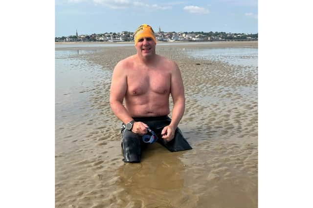 Simon Harmer on Ryde beach after swimming from Stokes Bay becoming what is believed to be the first double amputee to swim across the Solent.