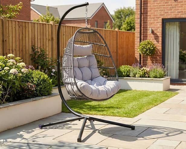 The dark grey hanging egg chair stands 202cm tall and comes with removable washable cushions