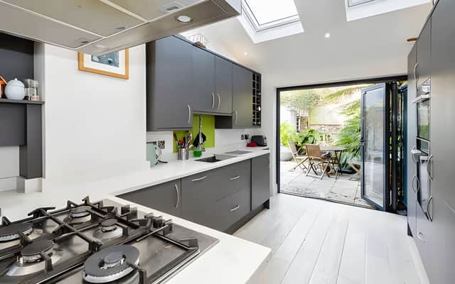 The impressive re-fitted kitchen has been designed as the heart of the home, with integrated appliances and bi-folding doors leading outside.