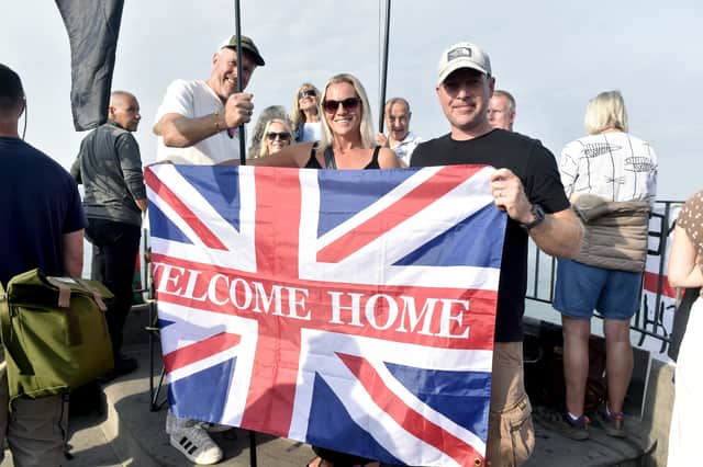 Pictured is: (middle and right) Donna Viv and Matthew Rogers, both excited to welcome home AB Lewis Hawkins (20) aboard HMS Prince of Wales. They travelled from Derbyshire.