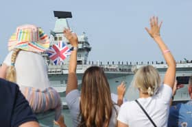 HMS Prince of Wales returning home to Portsmouth on Friday, July 24, 2026, after completing the first phase of Operation Firecrest. Families and friends gathered at the Hot Walls and the Round Tower in Old Portsmouth to welcome her home.