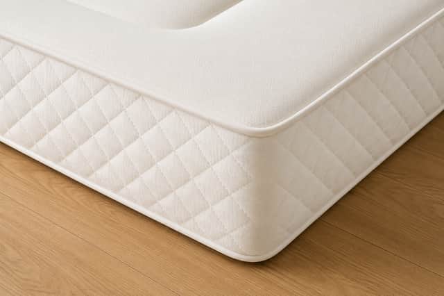 Deep-Sleep medium-firm mattress featuring open-coil support and a memory foam comfort layer