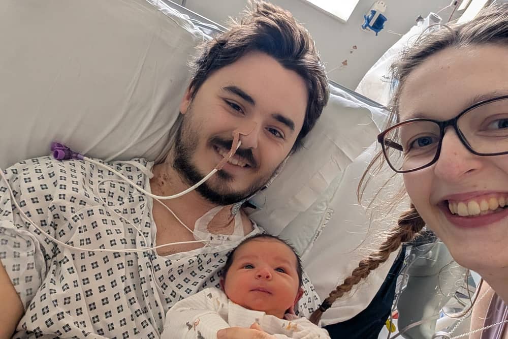 Sam King in hospital with his wife and daughter
