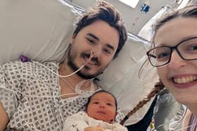 Sam King in hospital with his wife and daughter