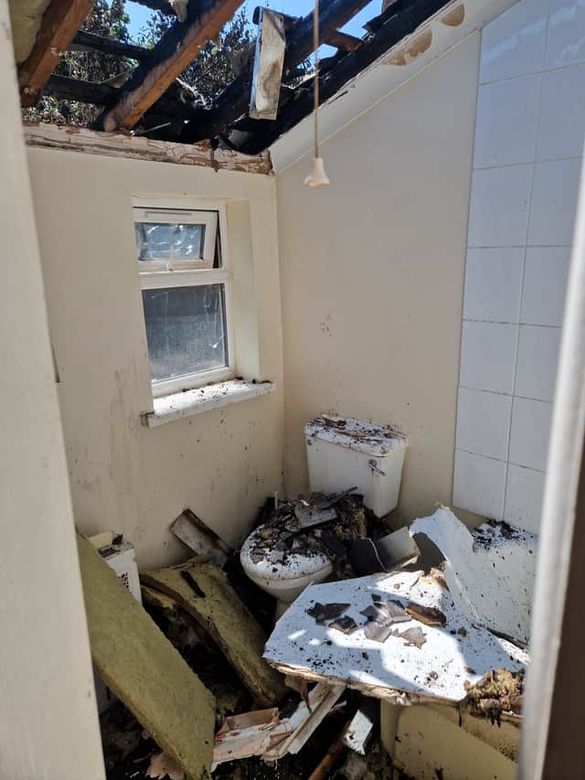 The blaze destroyed the roof of a downstairs bathroom