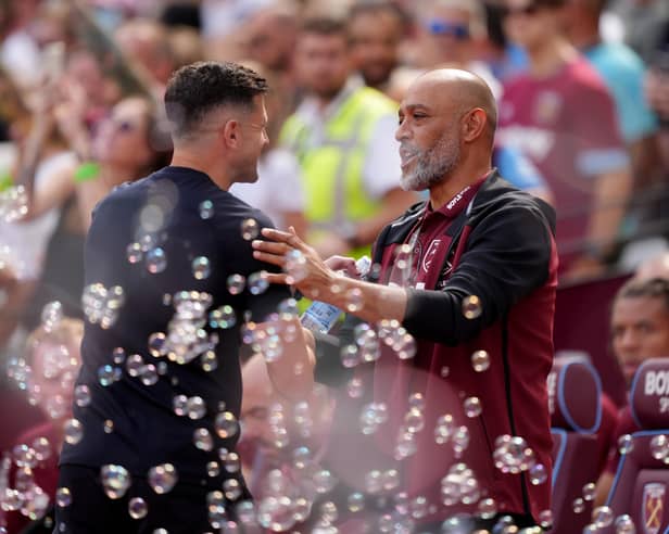 Pompey boss John Mousinho (left) greets West Ham United manager Nuno Espirito Santo. Pic: PA