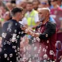 Pompey boss John Mousinho (left) greets West Ham United manager Nuno Espirito Santo. Pic: PA