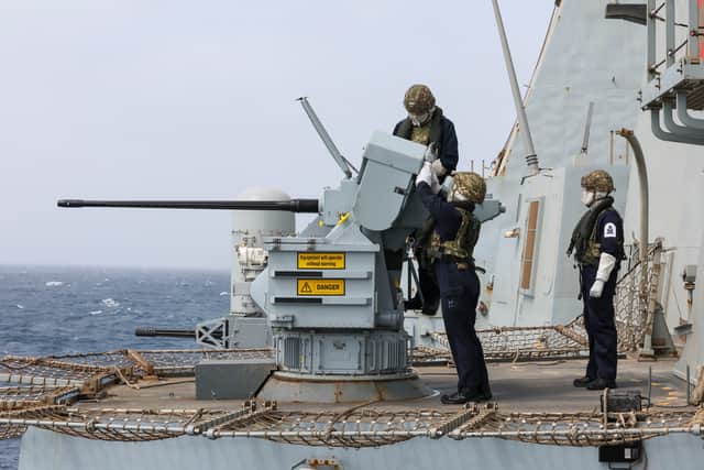 Gun Crew wearing protective equipment operating one of the 30 mm Small Calibre Guns during live firing/gunnery serials on board HMS Dragon.