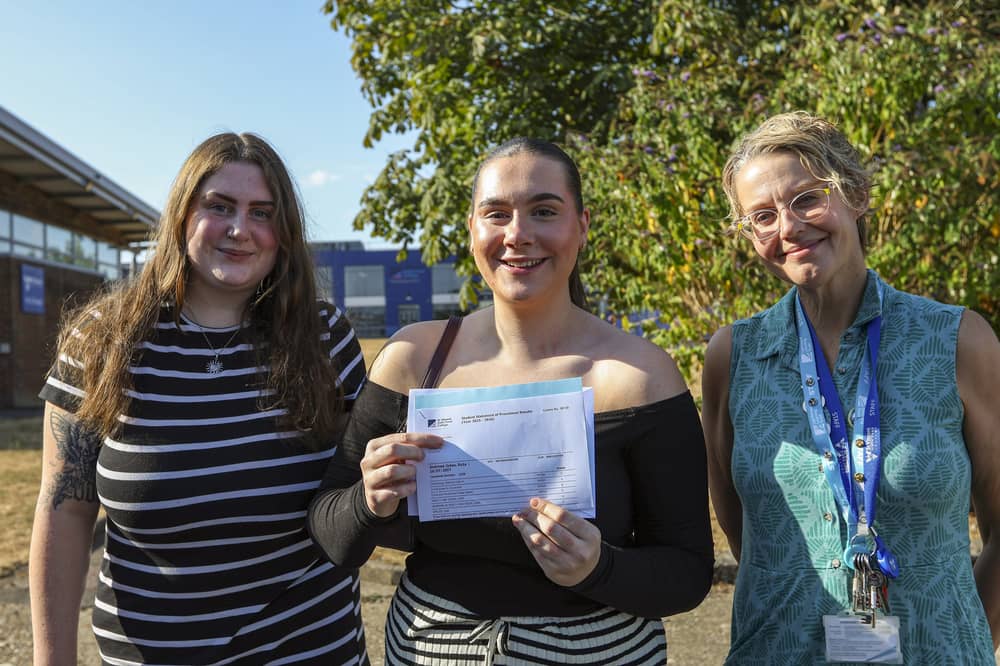Ruby Andrews-Jukes, centre, got distinction star in health and social care and in law, and a C in criminology. A-levels results day, St Vincent Sixth Form College, Gosport
