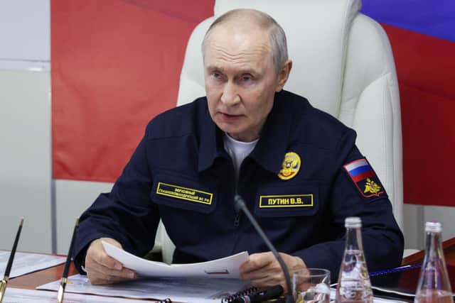 In this pool photograph distributed by the Russian state agency Sputnik, Russia's President Vladimir Putin holds a meeting onboard the Russian Navy's guided missile cruiser Varyag during the final stage of a Pacific Fleet's naval drills on far eastern Sakhalin Island on August 12, 2026. He said British ships will be seized following recent actions by European nations.