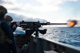 Ship's company aboard HMS Medway firing guns during Operation Southern Vigilance at the edge of the Falkland Islands.
