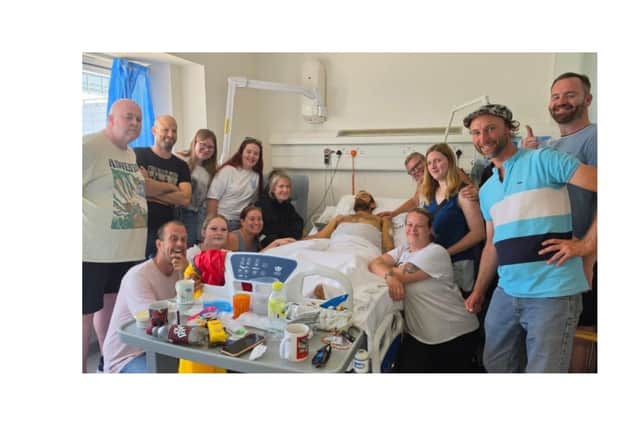 Jay Davis surrounded by loved ones at hospital