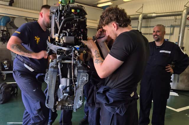 HMS SULTAN marine engineering apprentices work on the engine of GAFIRS' inshore lifeboat, Ian Fuller ILB.