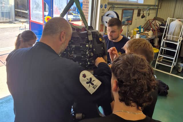 HMS SULTAN marine engineering apprentices work on the engine of GAFIRS' inshore lifeboat, Ian Fuller ILB.