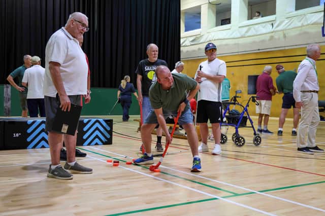 First-time camper Steve Parnell, a former RAF steward, takes part in Sports Day activities during his first Blind Veterans UK Summer Camp at HMS Sultan.
