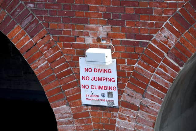 A warning sign at The Round Tower in Old Portsmouth.