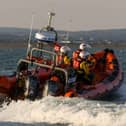 RNLI crews saved brought two people to safety after their vessel was taking on water.