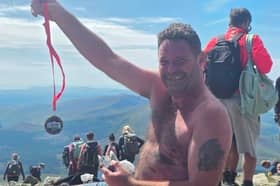 Danny with his summit medal at the top of Snowdon 