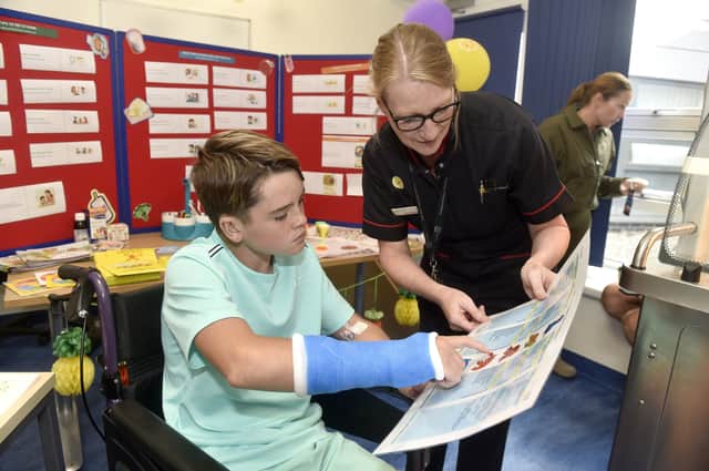 Max Jordan, 11, explores the new paediatrics menu on offer at QA Hospital with Gina Stanley, divisional nurse director.
