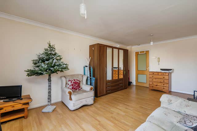 The spacious first-floor living room opens onto a balcony with picturesque views across the harbour