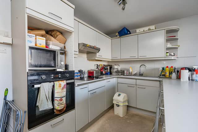 The modern kitchen and dining room combines integrated appliances with a practical ground-floor layout