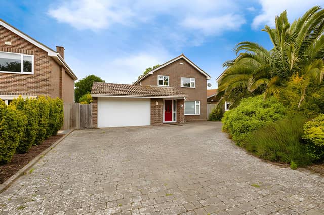 The Fort Road frontage provides generous off-road parking alongside access to the large garage and workshop