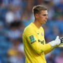 Alex Bass rubs his gloves together