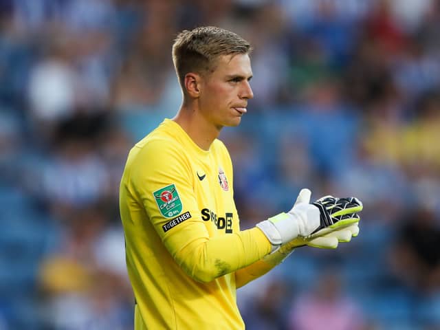 Alex Bass rubs his gloves together