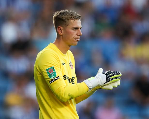 Alex Bass rubs his gloves together