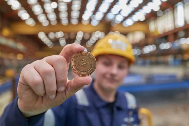 The ceremonial coin being placed into RFA Resurgent.