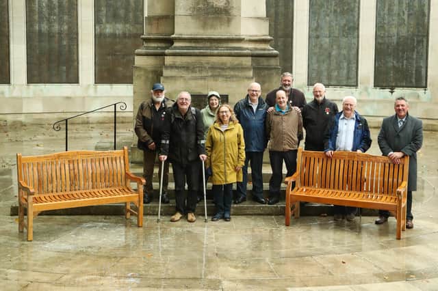 From L: Ian Whitewood, Graham Filer, Christine Whitewood, Cllr Suzie Horton, Gareth Lewis , Cllr Lee Hunt, Bob Beach, Chris Pennycook, Cllr Gerald Vernon-Jackson, and Carl Hiscock, standing with the benches before they head off to France.