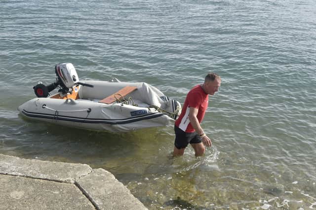 The aftermath at the RNLI in Ferry Road, Eastney, Portsmouth, on Monday, September 7, 2026, after hundreds of protestors descended on Portsmouth vowing to prevent 140 migrants who arrived in a small boat stepping onto dry land. 

Pictured is: Local singer Barry Williams retrieving his boat.

Picture: Sarah Standing (070926-6965)