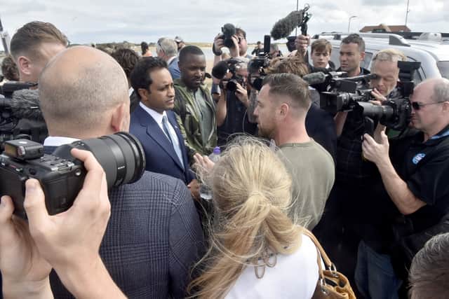 A media scrum around Zia Yusuf in Eastney Picture: Sarah Standing (070926-7024)