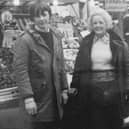 Gary, aged 13, with his grandmother at their family's fruit and veg stall 