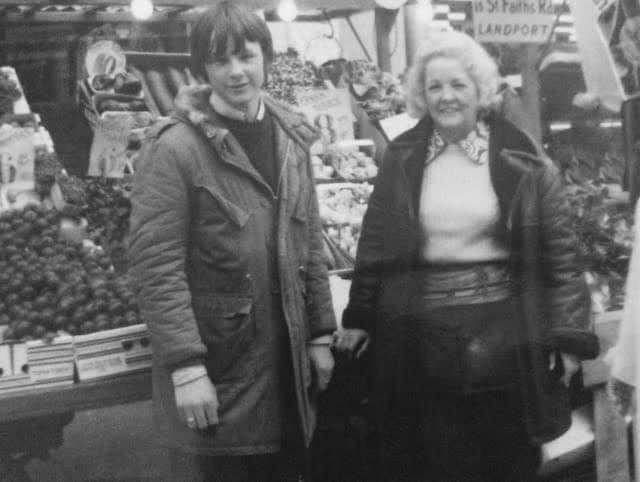 Gary, aged 13, with his grandmother at their family's fruit and veg stall