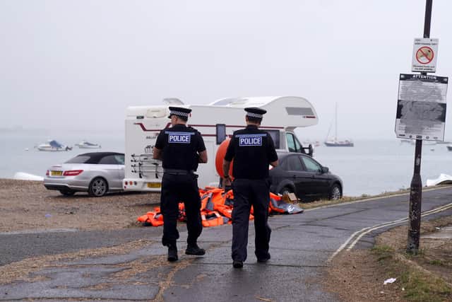 Police officers pass a pile of discarded life jackets at Eastney Ferry Landing.