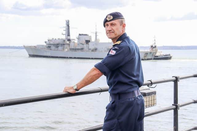 Commander George Blakeman watching retired Royal Navy ship HMS Northumberland being towed away from Portsmouth.