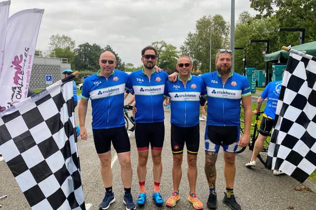 The 2025 STS Defence team at the finish line of last year's cycling challenge.
