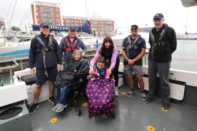 Members of the Rainbow Centre with visitors and crew on the WetWheels powerboat