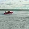 RNLI lifeboat crew from Hayling Island racing off to rescue a fisherman who was swept into the water.