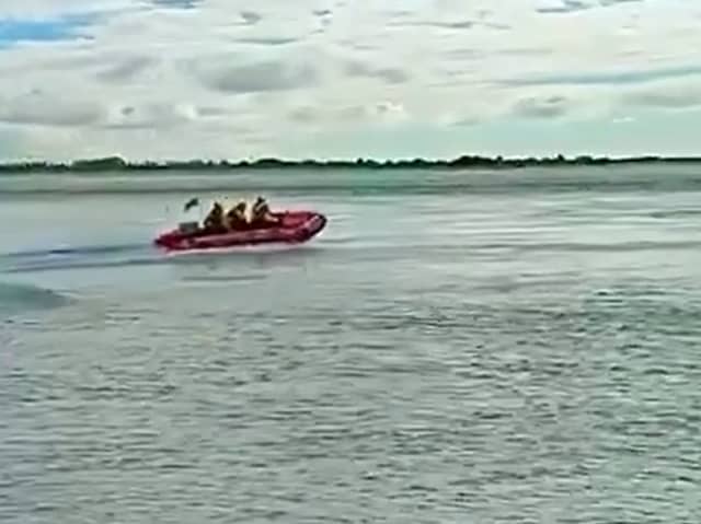 RNLI lifeboat crew from Hayling Island racing off to rescue a fisherman who was swept into the water.