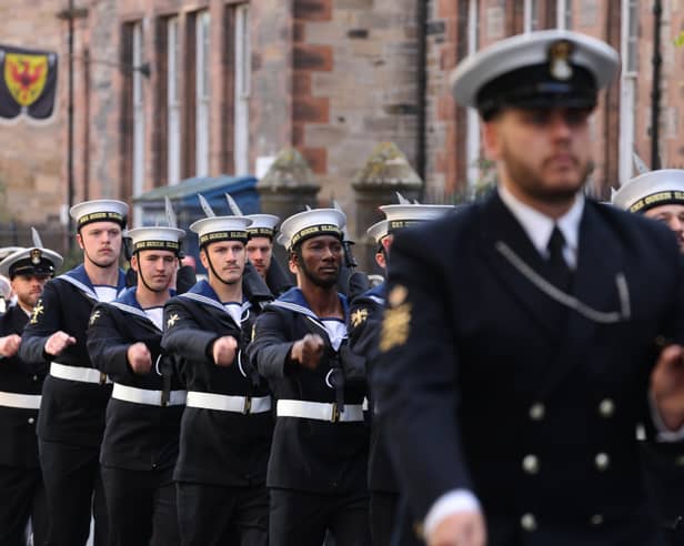 Sailors from HMS Queen Elizabeth and the Royal Marine Band march through Edinburgh.