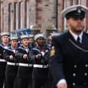 Sailors from HMS Queen Elizabeth and the Royal Marine Band march through Edinburgh.