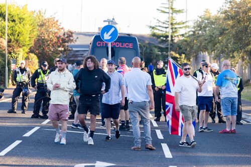 Police and protesters in Gosport, Hampshire after police closed off the access road to Haslar Marina, after British rescue boats have been sent to collect the passengers of a migrant dinghy which has spent around 30 hours at sea.